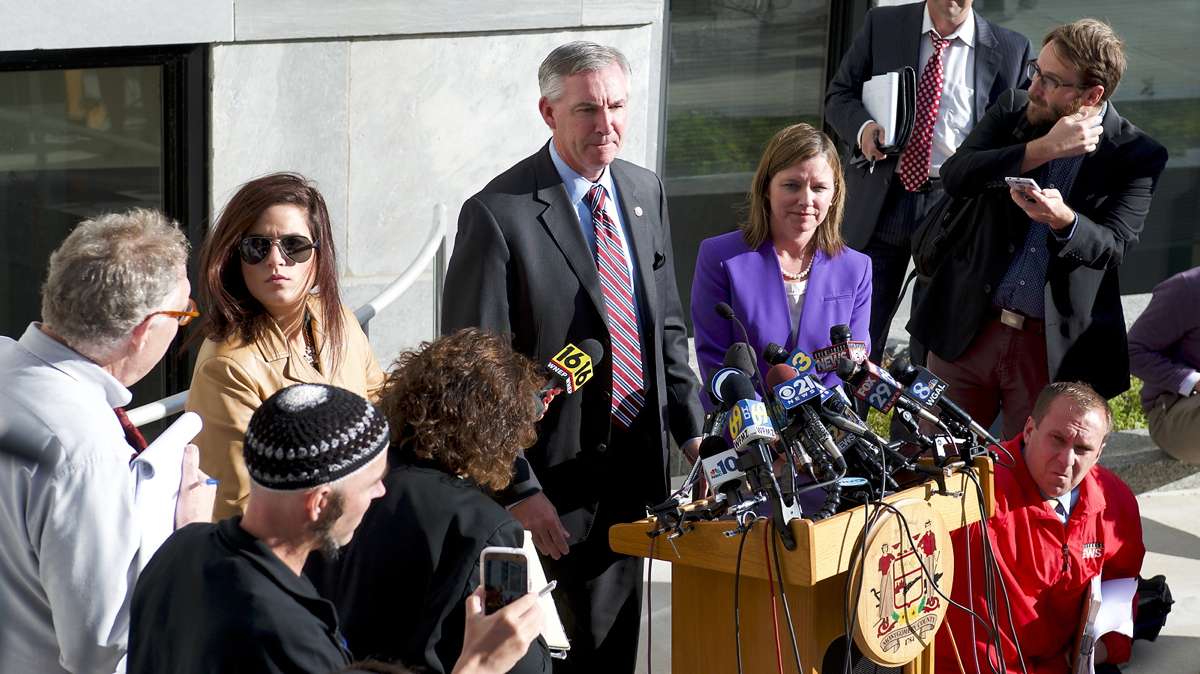 Jonathan Lee Riches is seen in the foreground (left) as Montgomery County District Attorney Kevin Steele talks to the media after former Pennsylvania Attorney General Kathleen Kane received a 10 to 23 months sentence, on Oct.24, 2016, at Montgomery County Court House. (Bastiaan Slabbers for NewsWorks)