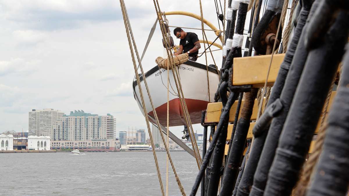 Gabe St-Denis looks after the ships tender aboard the Picton Castle as it arrives in Philadelphia. (Emma Lee/WHYY)