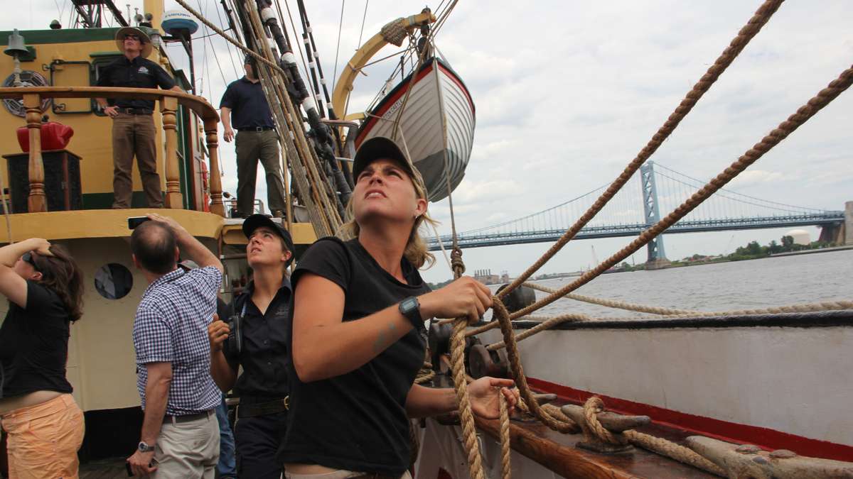Bos'n Erin Greig checks the lines as the Picton Castle gets underway leading the Parade of Ships  in the Tall Ships Festival on the Delaware. (Emma Lee/WHYY)