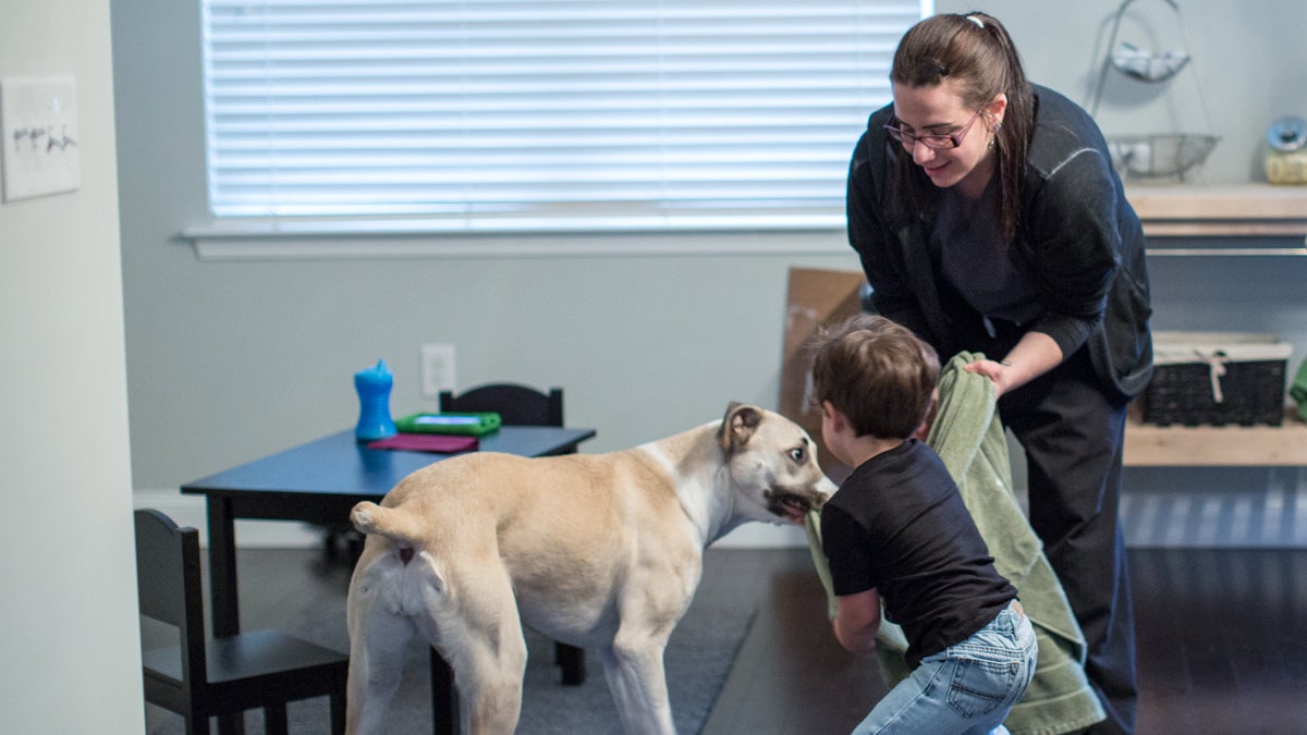  After the night shift in the ER, Dr. Dorian Jacobs spends time with her toddler and dog before heading to sleep. (Jessica Kourkounis/for WHYY) 