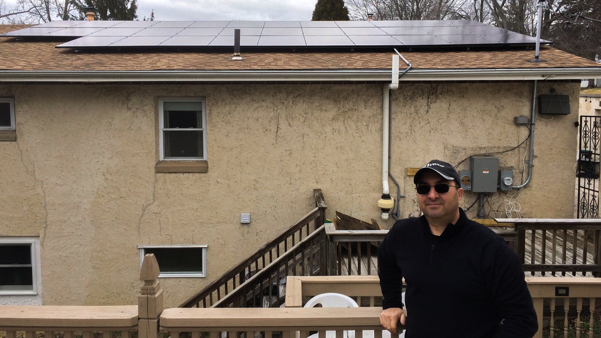 Sal Fede displays his new solar panels mounted on the roof of his Philadelphia home. (Joel Wolfram/for WHYY)