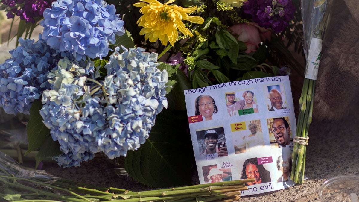  Flowers and notes of hope and support from the community line the sidewalk, Friday, June 19, 2015  in front of the  Emanuel AME Church in Charleston, S.C. Dylann Storm Roof, 21, is accused of killing nine people during a Wednesday night Bible study at the church.  (AP Photo/Stephen B. Morton) 
