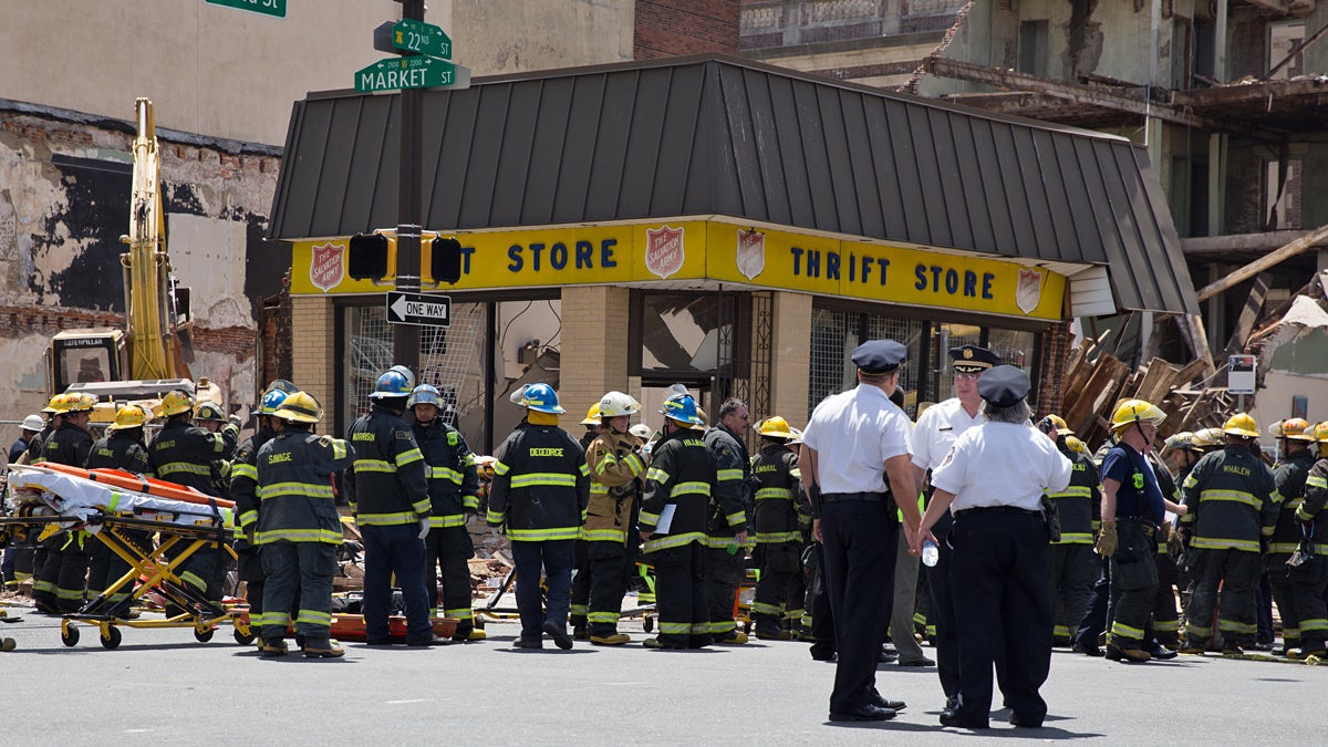  Philadelphia Fire Department personnel surround the Salvation Army Thrift Store at 22nd and Market streets in Center City on Wednesday, June 5, 2013. (Lindsay Lazarski/WHYY) 