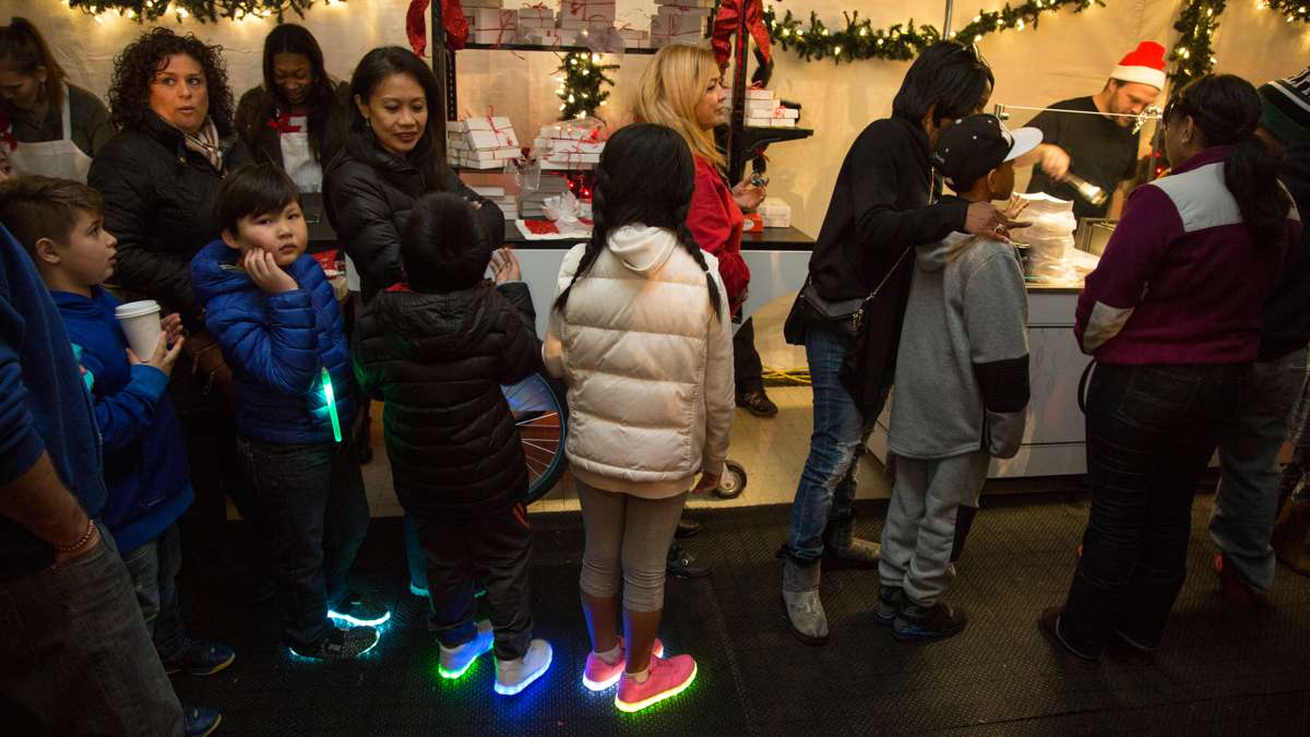 Familes wait in line for fresh donuts at The Franklin Square Holiday and Light Festival. The festival runs November 10 through December 31 and is free to the public.