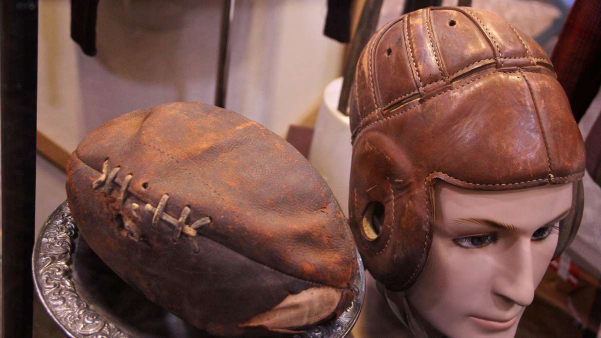 A helmet and football used by Jim Thorpe occupies a glass case in the center of the museum. (Emma Lee/WHYY)