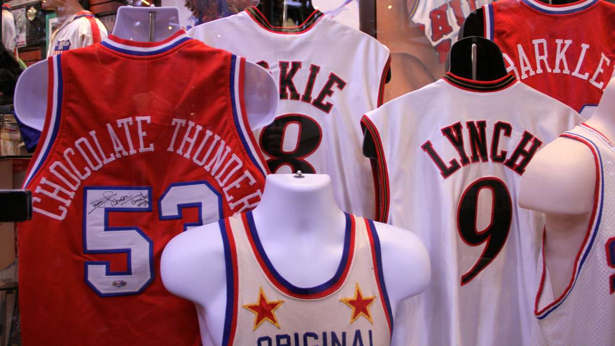 A basketball jersey display includes one signed by Darryl Dawkins, also known as Chocolate Thunder. (Emma Lee/WHYY)