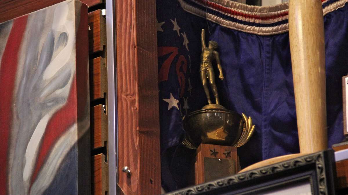 Tucked away in the corner of a shadowbox is a small trophy commemorating Wilt Chamberlain's 75-point performance when he played for Overbrook High School. (Emma Lee/WHYY)