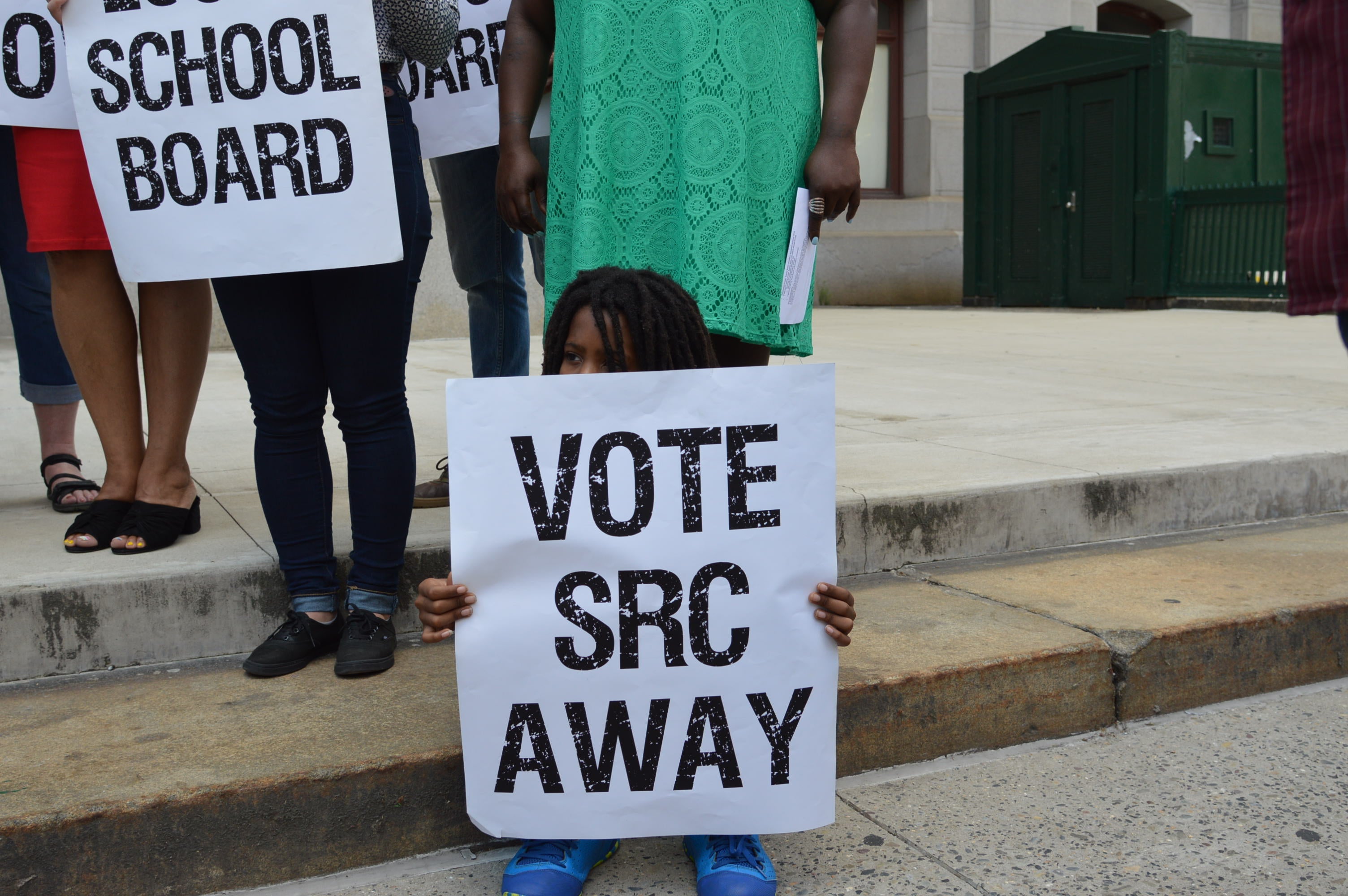  A child holds up a sign at recent rally calling for an end to the School Reform Commission.  (Tom MacDonald/ WHYY) 