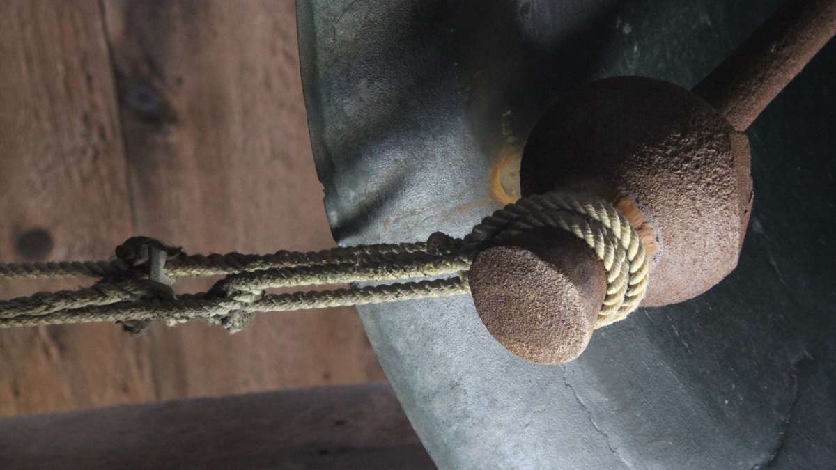 A tug on a rope below brings a clapper into contact with a bell in St. Peter's tower, a system that has served for more than 200 years. (Emma Lee/for NewsWorks)