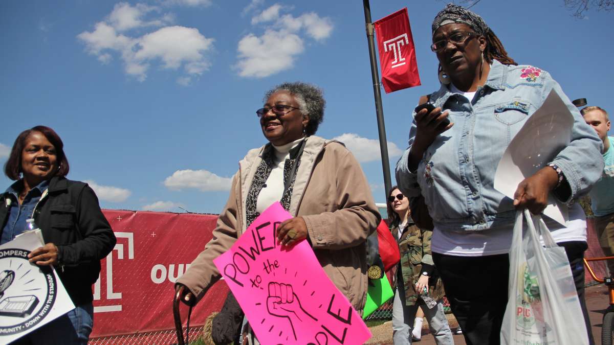  Jacqueline Wiggins (center), a long time resident of the Temple University area, joins her neighbors and students in an April 2016 protest march against a proposed new football stadium. (Emma Lee/WHYY) 