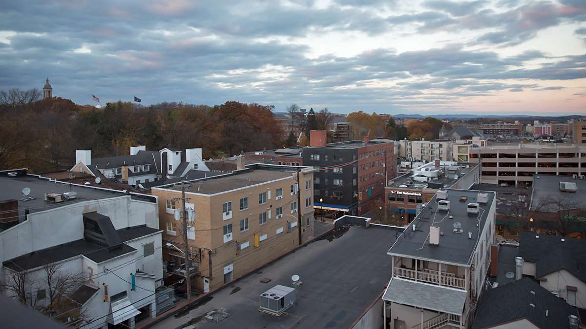 Bird’s eye view of downtown State College, Pa. from near Pugh Street. The bell tower of Old Main (far left) peaks over the trees on Penn State campus. (Lindsay Lazarski/WHYY)