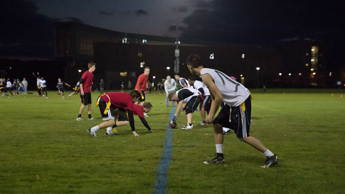 A group of students play intramural flag football on a fall evening at Penn State University. (Lindsay Lazarski/WHYY)
