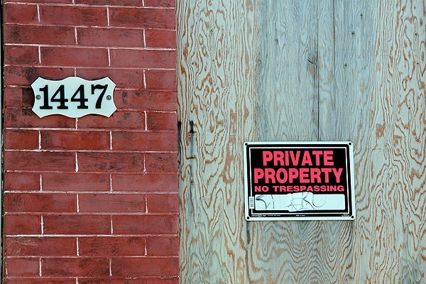 <p>Private property, but whose? Investigators say this boarded up row home on Bancroft Street was one of 22 city properties stolen by men who forged the deeds. (Emma Lee/for NewsWorks)</p>
