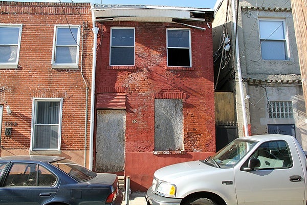 <p>Investigators say this crumbling row home at 1120 Clifton Street was stolen by men who forged the deed. "Why would you steal that," wondered a passing pedestrian. "What would you do with it?"</p>
