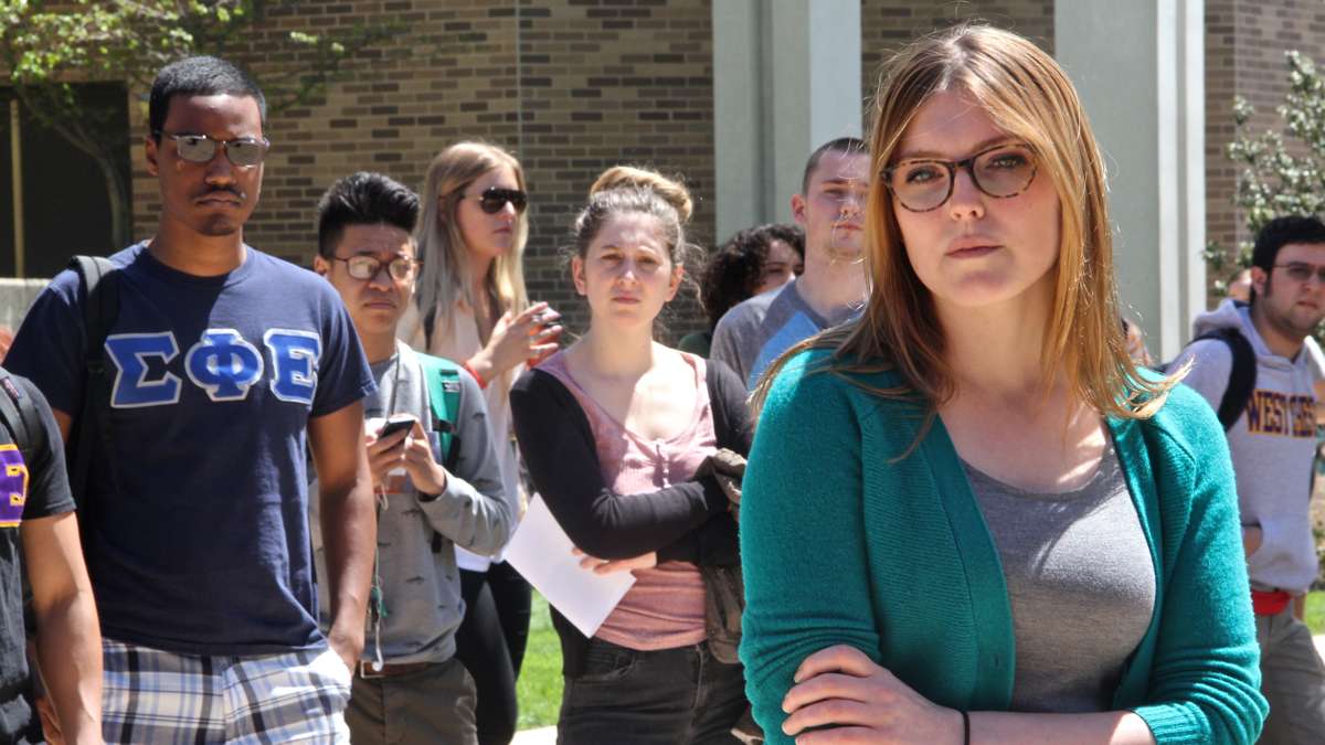 West Chester junior Shannon Bertoni (right) tells her story of sexual assault to a gathering of students and media during a rally on the campus quad. (Emma Lee/for NewsWorks)