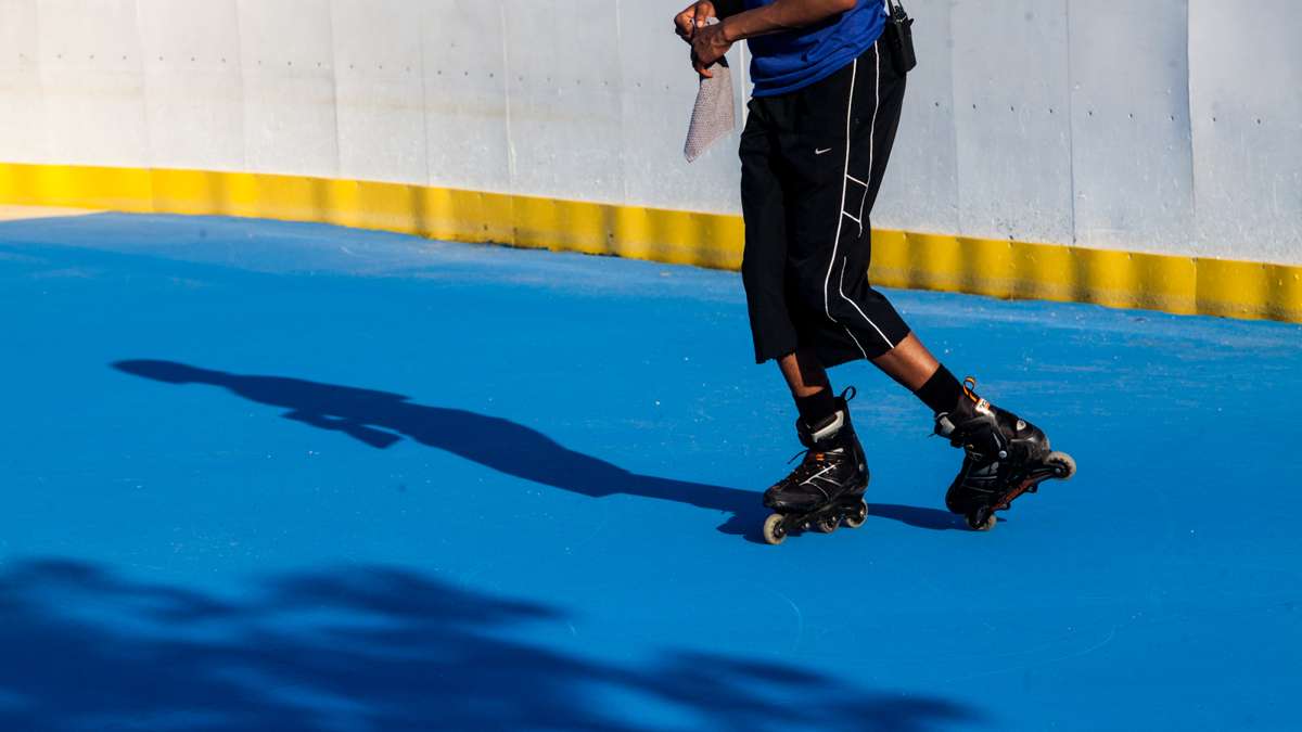 A staff member skates around the River Rink. (Brad Larrison for NewsWorks)