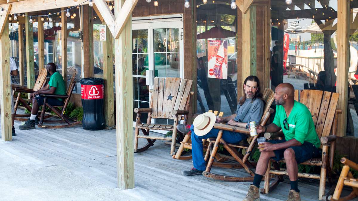 Guests hang out on the porch at the lodge at the River Rink at Penn's Landing.
