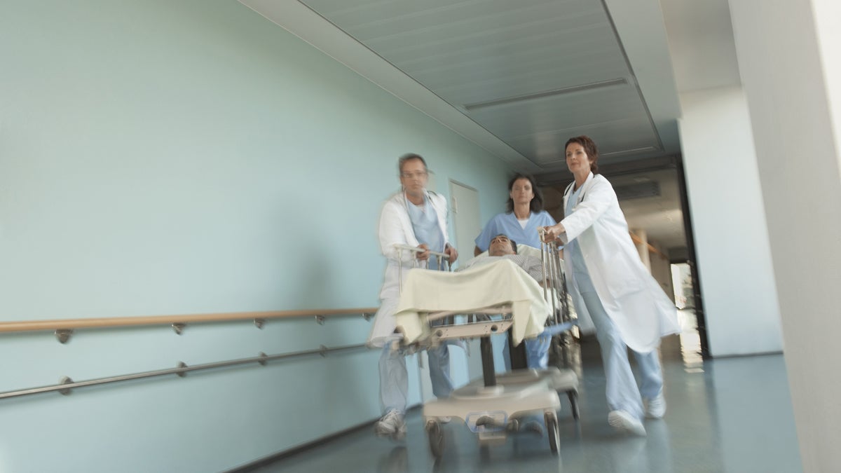  Hospital workers move a patient to surgery.  (<a href=