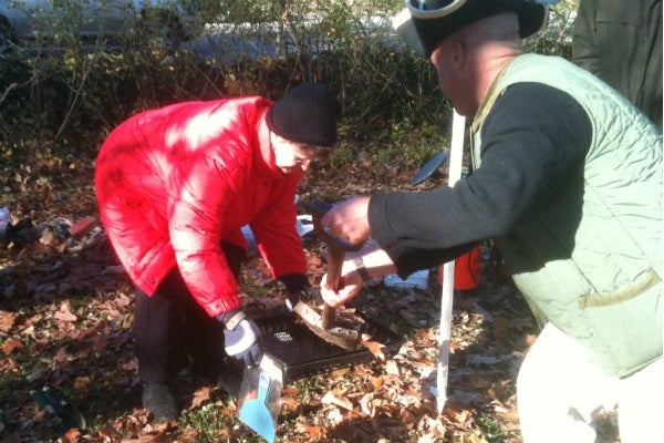 <p><p>Eugene Hough fills the sifting pan of Friends of Lovett President Sheila Incognito with a small shovelfull of surface dirt. The small number of volunteers available to sift the dirt meant that the excavation of the plot along Germantown Avenue only went down a few inches, instead of the 18 inches originally planned. (Karl Biemuller/for NewsWorks)</p></p>
