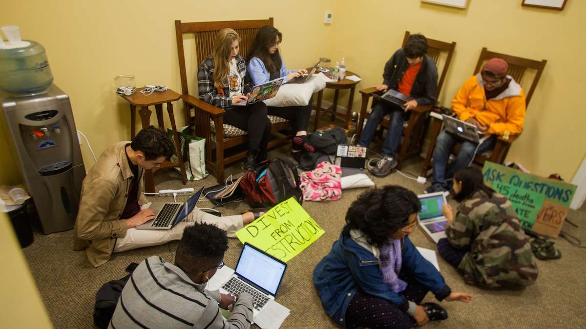 Swarthmore College students gather near the office of the president during day two of a sit-in to call for an end to the college's investment in fossil fuels. (Brad Larrison/WHYY)