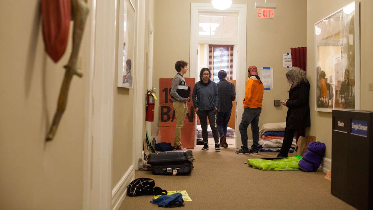 Swarthmore College students gather near the office of the president during day two of a sit-in to call for an end to the college's investment in fossil fuels. (Brad Larrison/WHYY)