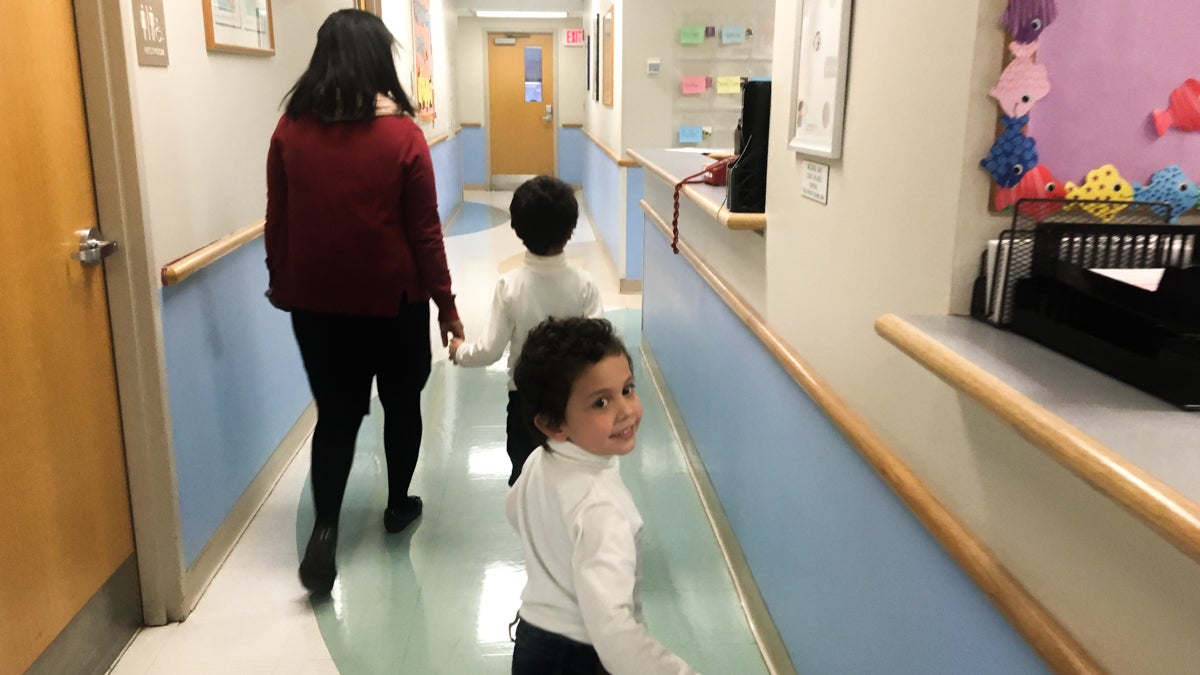 The Taweels arrived in the U.S. in January as Syrian refugees. Shortly after, they went to Einstein’s pediatric clinic for their first comprehensive health exam in the U.S. Dr. Raghava Kavalla walks with the two boys, 6-year-old Ghassan and four-year-old Anas, to an exam room. (Elana Gordon/WHYY)