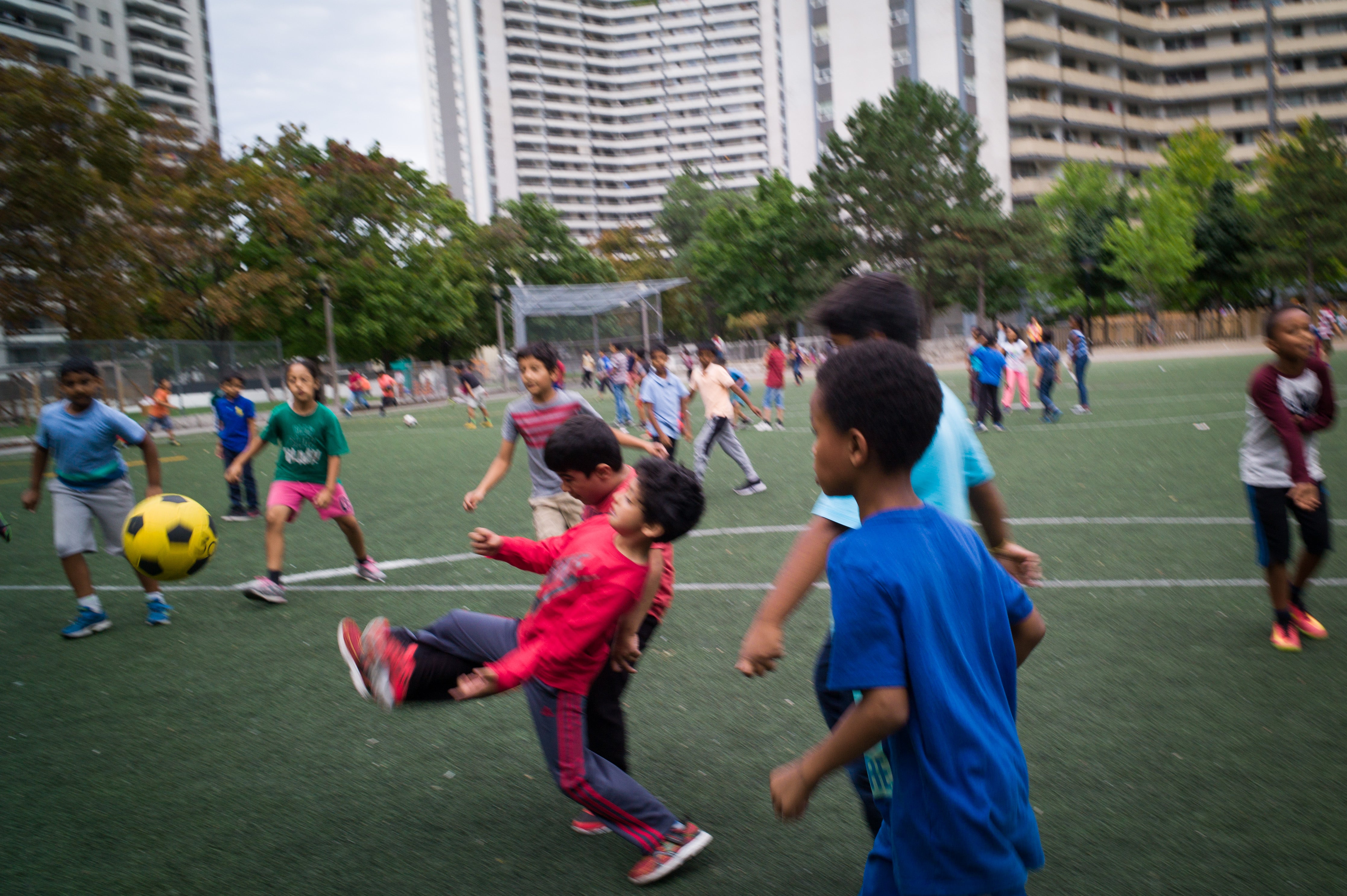 Students play soccer during recess, at Rose Avenue Public School in Toronto, Ontario, Canada. (Ian Willms/For Keystone Crossroads)