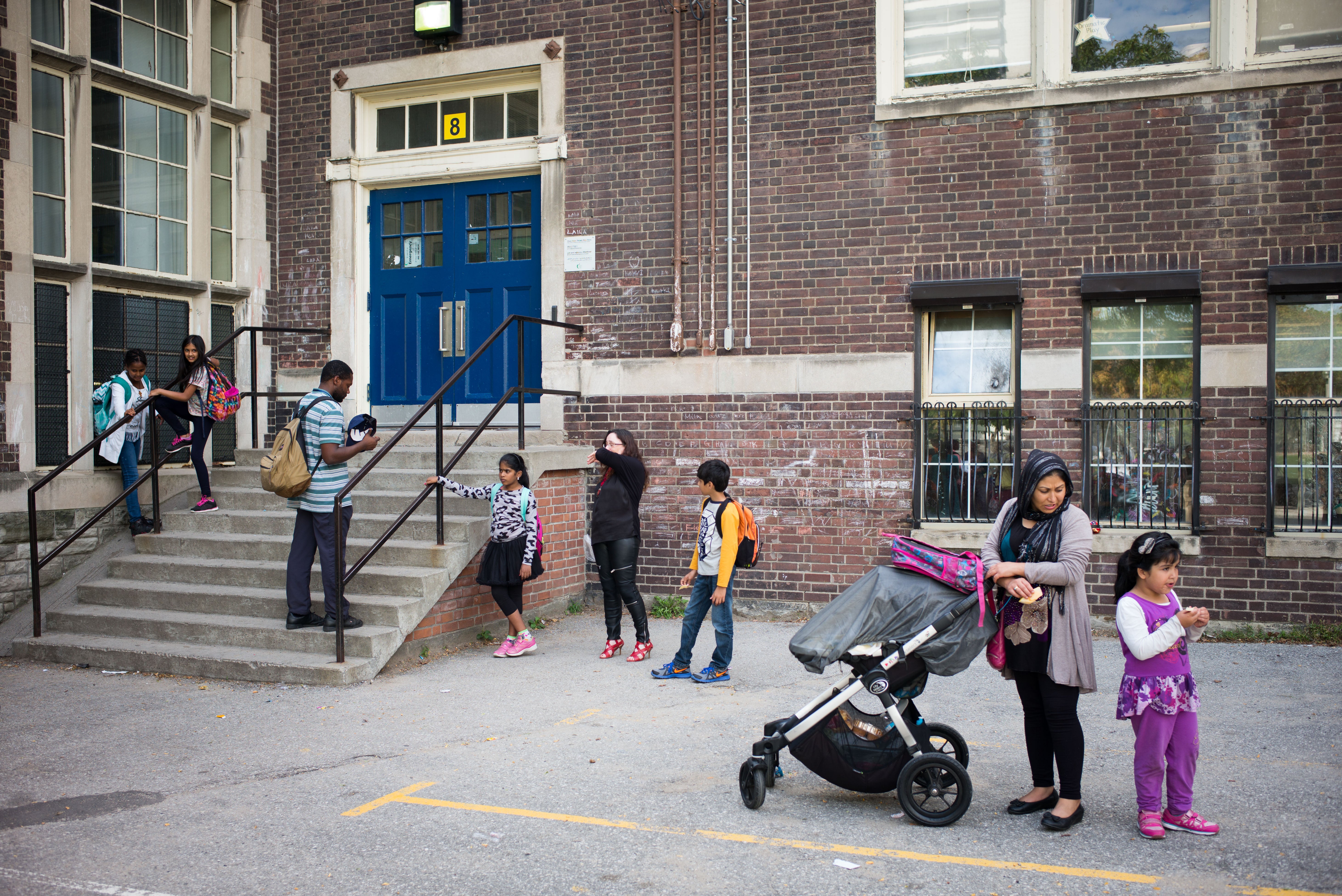 Families wait for students outside Rose Avenue Public School in Toronto, Ontario, Canada. (Ian Willms/For Keystone Crossroads)