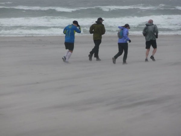 The rain and strong winds continued as runners made their way along the shoreline in full rain gear. (Photo courtesy of Steve Antczak)