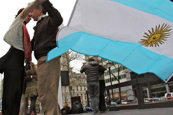 <p>The Argentine flag flaps in a chilly breeze as dancers demonstrate Argentine tango as part of a cultural outreach organized by the Embassy of Argentina. (Emma Lee/for NewsWorks)</p>
