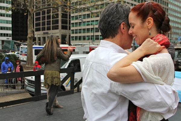 <p>Stephen Macbeth and Meredith Klein tango on the stage at Love Park, demonstrating the Argentine style as part of a celebration of Argentine culture organized by the Embassy of Argentinia. (Emma Lee/fvor NewsWorks)</p>
