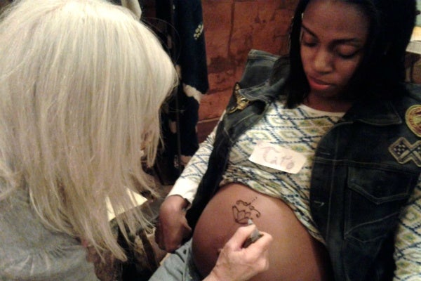 <p><p>Jeanyne Hicks receives a Henna design from Gina Gruenberg. (Alaina Mabaso/for NewsWorks)</p></p>
