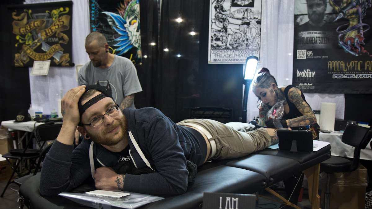 Artist Alexandra Fische tattoos Michael Myers onto horror fan Paul Heiler. (Kimberly Paynter/WHYY)