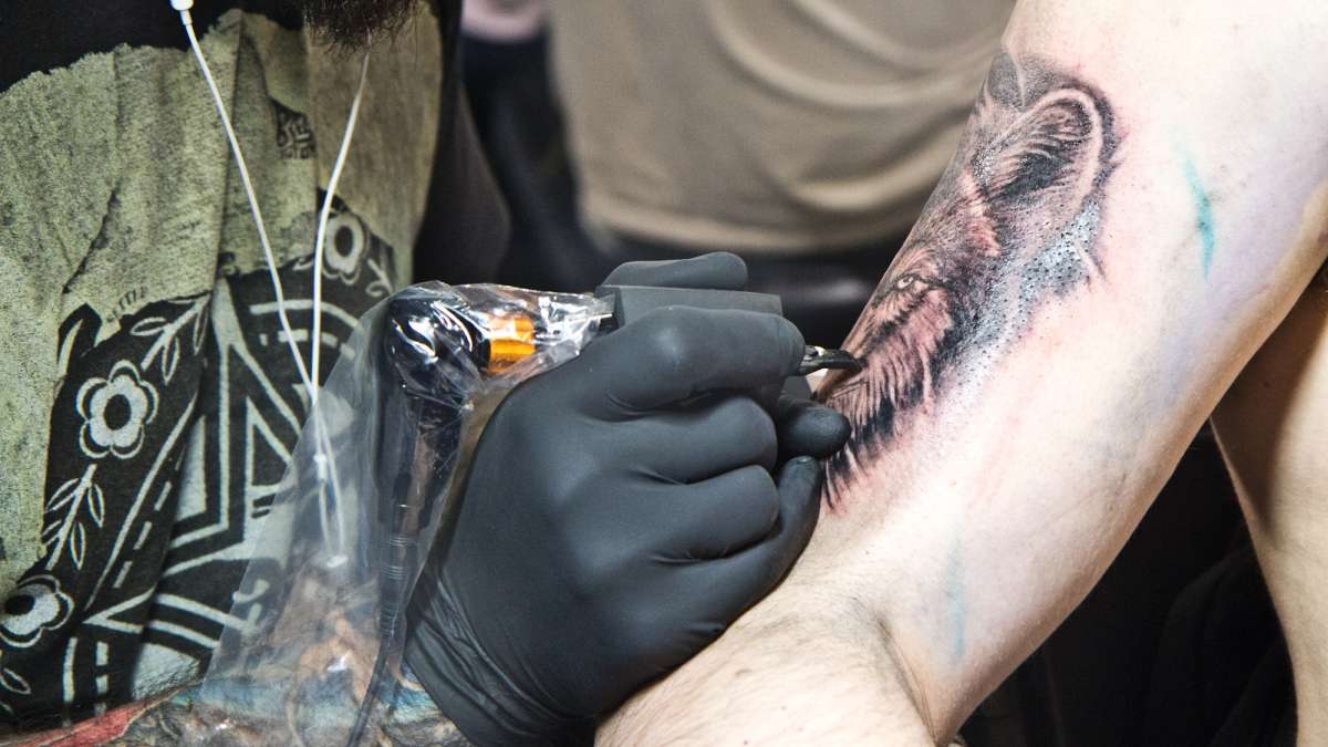 Branden Stiffler receives a wolf tattoo from artist Corey James in honor of his grandmother.