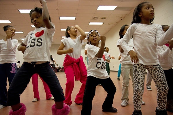 Members of the Camden Sophisticated Sisters practice a routine to the tune of the Elmo theme song for an upcoming performance.  (Lindsay Lazarski/WHYY)
