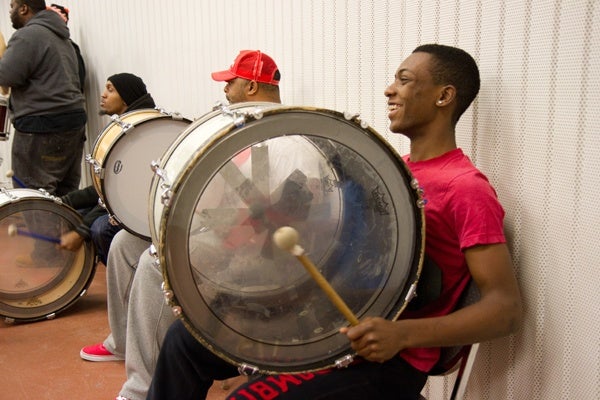 Mateo Jones, 15, keeps busy by  keeping the bass line drum beat for the Camden Sophisticated Sisters about two days a week.  (Lindsay Lazarski/WHYY)
