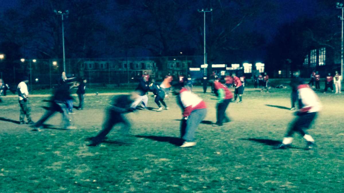 The Imhotep Panthers have a playoff game on the schedule two days after the Thanksgiving 'Legacy Bowl,' but on Thursday, it was a coaches vs. players game at their East Germantown practice field. (Brian Hickey/WHYY)