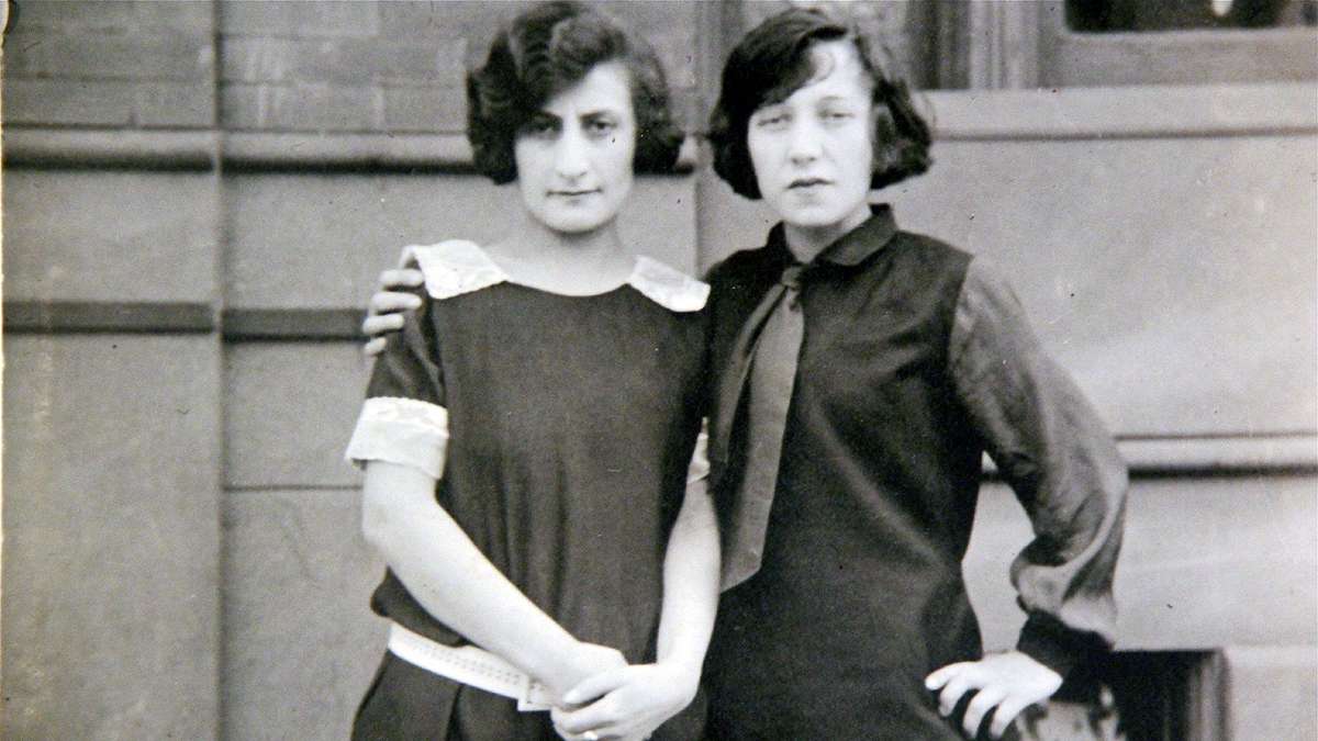 A woman wearing a necktie embraces another woman in an anonymous photo from the early 20th century. Is it gay? The Library Company of Philadelphia explores that question and others with a new exhibit. (Emma Lee/for NewsWorks)