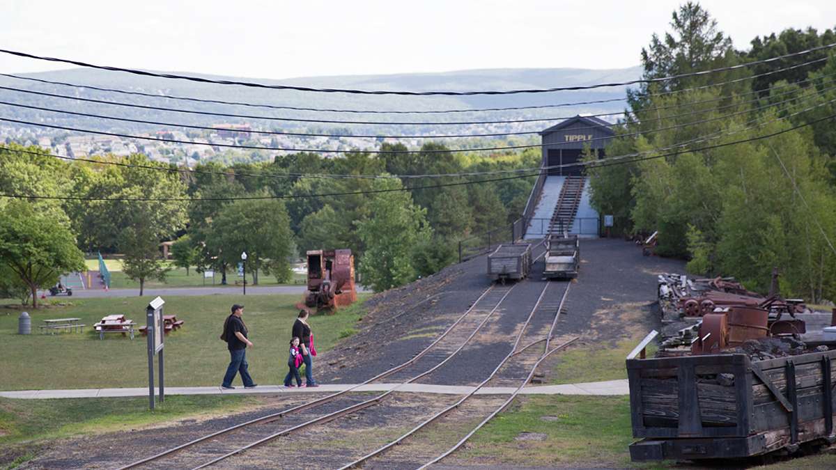  Visitors tour the grounds of McDade Park. Once coal mining terrain, the park is home of the Anthracite Heritage Museum, Lackawanna coal mining tour, and other recreation areas. (Lindsay Lazarski/WHYY) 