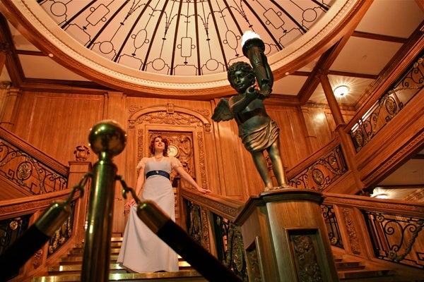 Franklin Institute volunteer Jaclyn Scarborough, portraying silent film actress Dorothy Gibson, descends a replica of the Titanic's grand staircase. (Emma Lee/for NewsWorks)