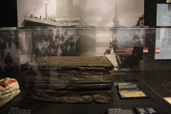 Ordinary objects like this leather suitcase and trolley tickets became extraordinary after surviving the sinking of the Titanic and years beneath the sea. (Emma Lee/for NewsWorks)