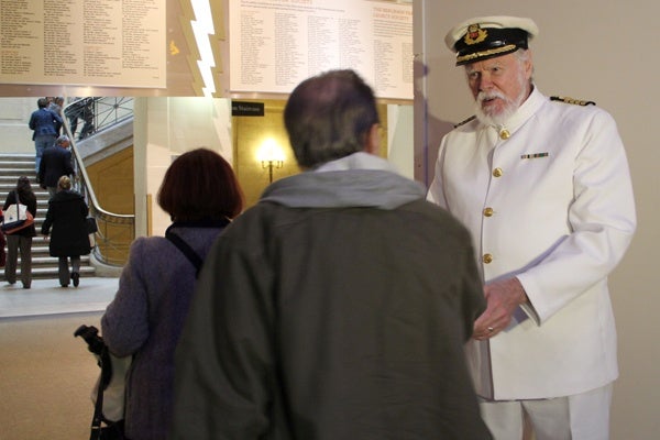 Lowell Lytle, an actor portraying Titanic Captain Edward John Smith welcomes visitors to the Franklin Institute's new exhibit. (Emma Lee/for NewsWorks)