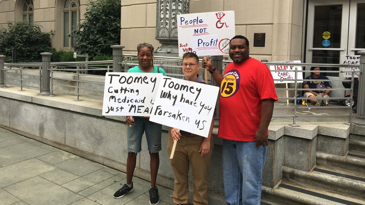  Disability activists demonstrate Tuesday outside the office of U.S. Sen. Pat Toomey at the  Custom House in Philadelphia. (Jay Scott Smith/WHYY) 