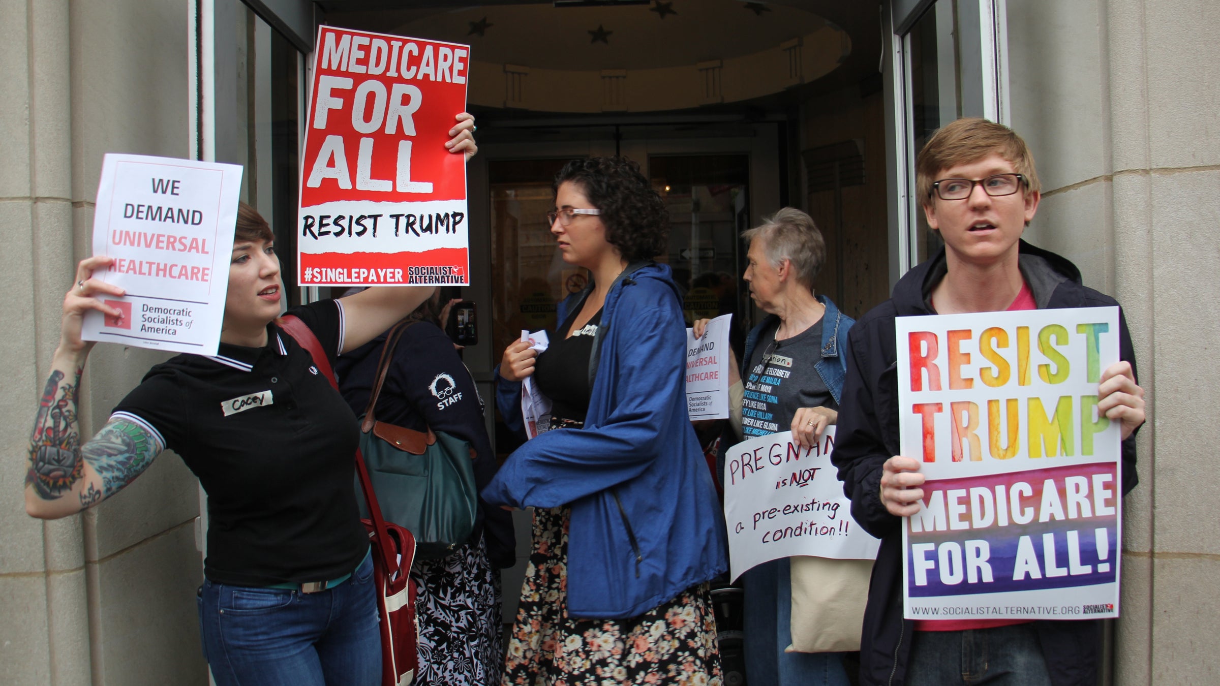  Protesters gather outside the U.S. Custom House where U.S. Sen. Pat Toomey of Pennsylvania has his Philadelphia office. (Emma Lee/WHYY) 