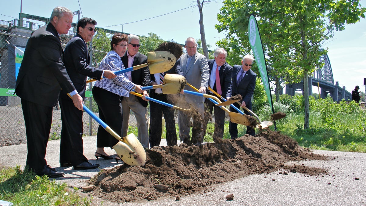 Philadelphia mayor Jim Kenney (left) and other elected and appointed officials ceremoniously break ground for the Kensington and Tacony trail. (Emma Lee/WHYY)