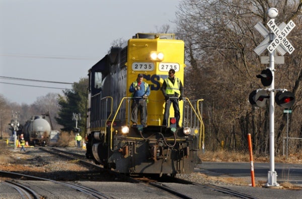 <p><p>Crew members ride on a locomotive after leaving empty tank cars near derailed train cars in Paulsboro, N.J., on Saturday. (AP Photo/Mel Evans)</p></p>
