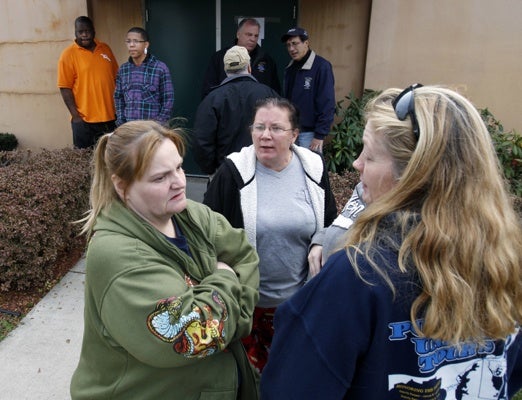 <p><p>Displaced residents wait for a shuttle bus outside a fire hall and community center in Paulsboro, N.J., Saturday. (AP Photo/Mel Evans)</p></p>

