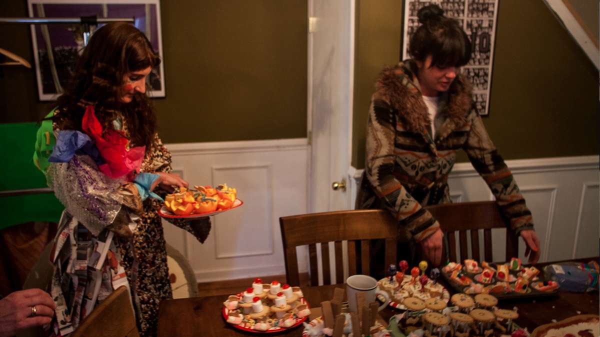 Jenny Drumgoole (aka 'Soxx') and Allison Sexton prepare treats for city sanitation workers outside for 'Happy Trash Day' on Dreer Street in East Kensington. (Brad Larrison/for NewsWorks)