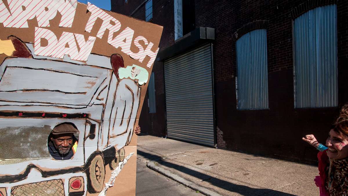 A sanitation worker strikes a pose in the Happy Trash Day attraction. (Brad Larrison/for NewsWorks)