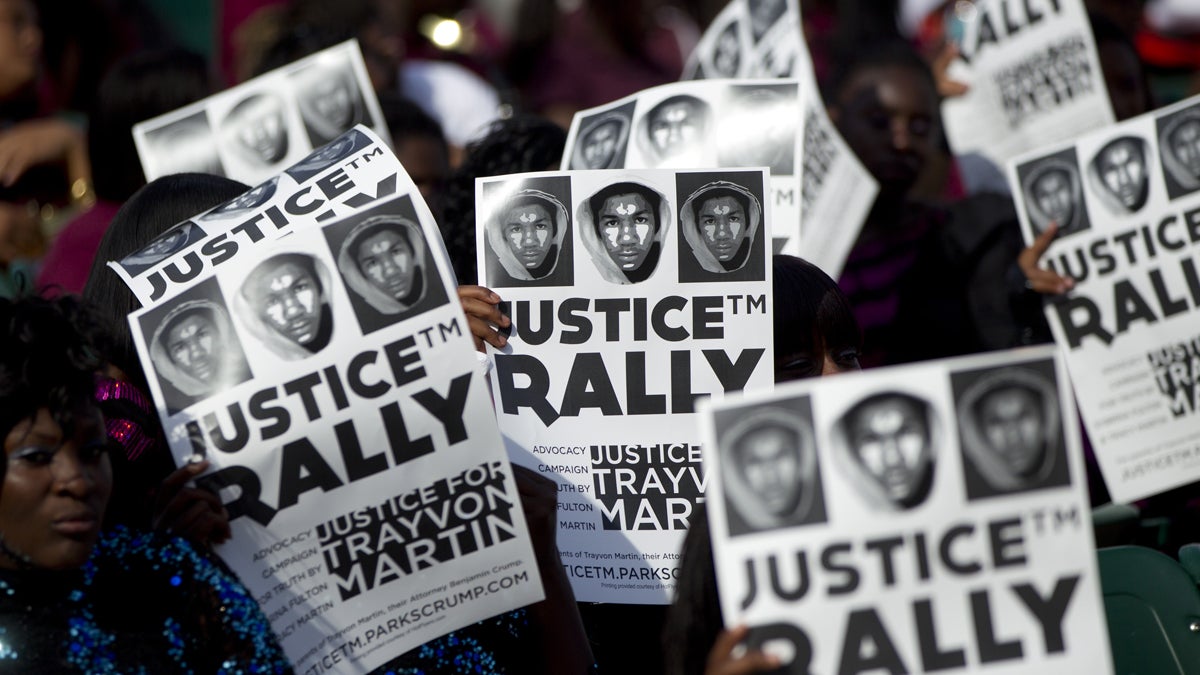  People at a rally in downtown Miami in 2012 hold signs demanding justice for Trayvon Martin. (AP Photo/J Pat Carter, file) 